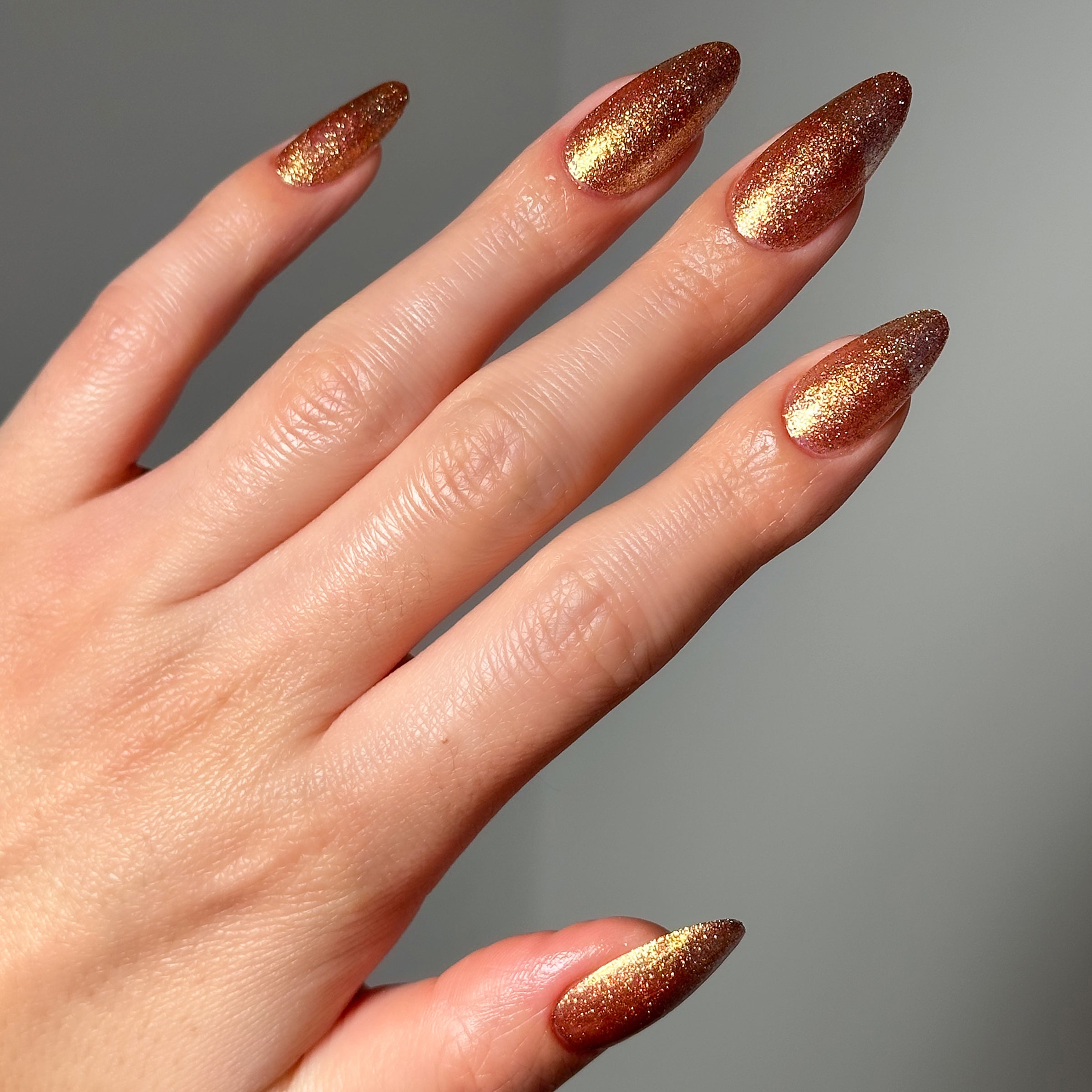 Close-up of a model's hand wearing Salon Perfect Flash Nail Lacquer .5oz 435 Bling It On.