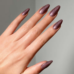 Close-up of a model's hand wearing Salon Perfect Flash Nail Lacquer .5oz Gliterally Obsessed
