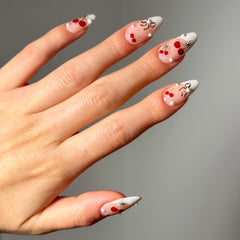 Close-up shot of a model's hand wearing Salon Perfect Nail Art Stickers Bows and Cherries.