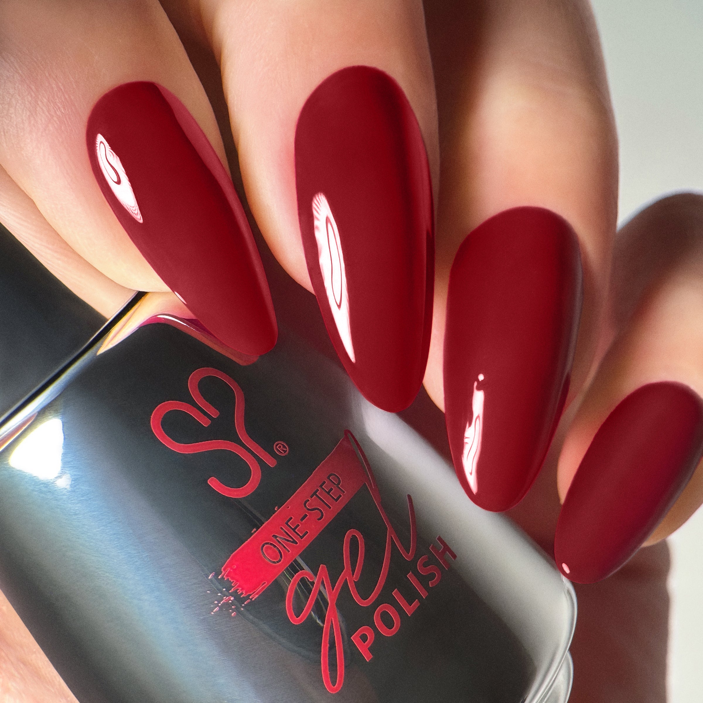 Close up shot of model holding Salon Perfect .5OZ 1-Step Gel Cherry Mochaccino bottle.