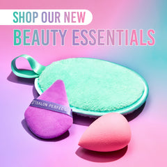 Three beauty products on a gradient pink and purple background with text 'Shop Our New Beauty Essentials'.