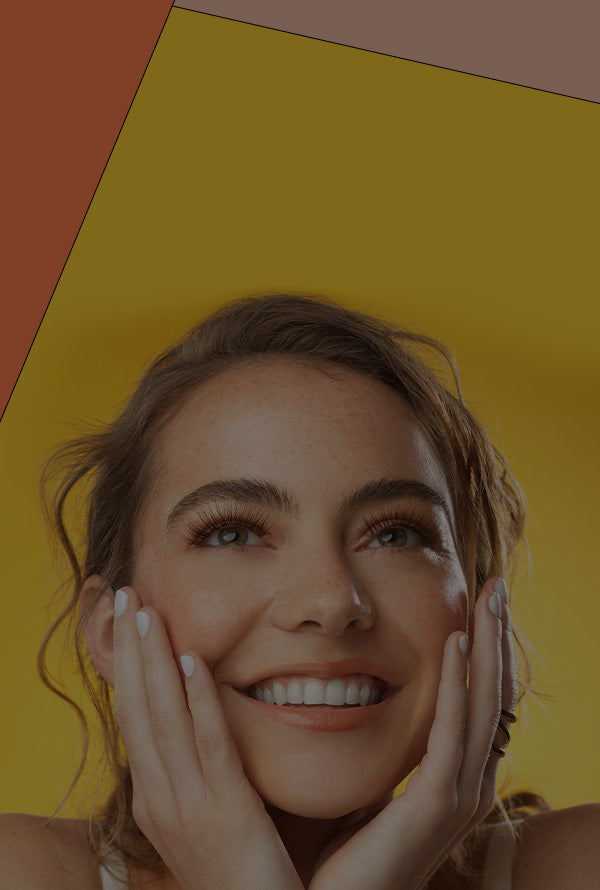 Woman with a bright smile against a yellow background