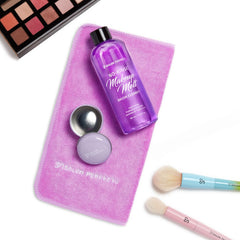 Makeup cleaning products including No Rinse Brush Cleaner, 6.5 Fluid Oz bottle, sponges, and brushes on a pink towel with 'Salon Perfect' branding.