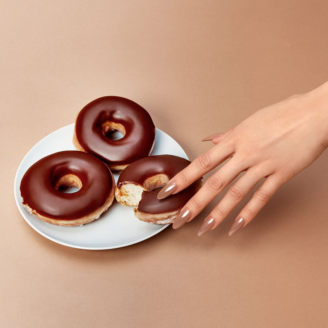 A stylize image of Salon Perfect Glazed Chocolate Artificial Nail Set modeled on hand