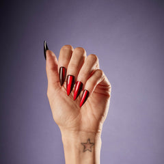 Hand wearing SALON PERFECT NAIL 228 RED MAGNETIC STILLETO 