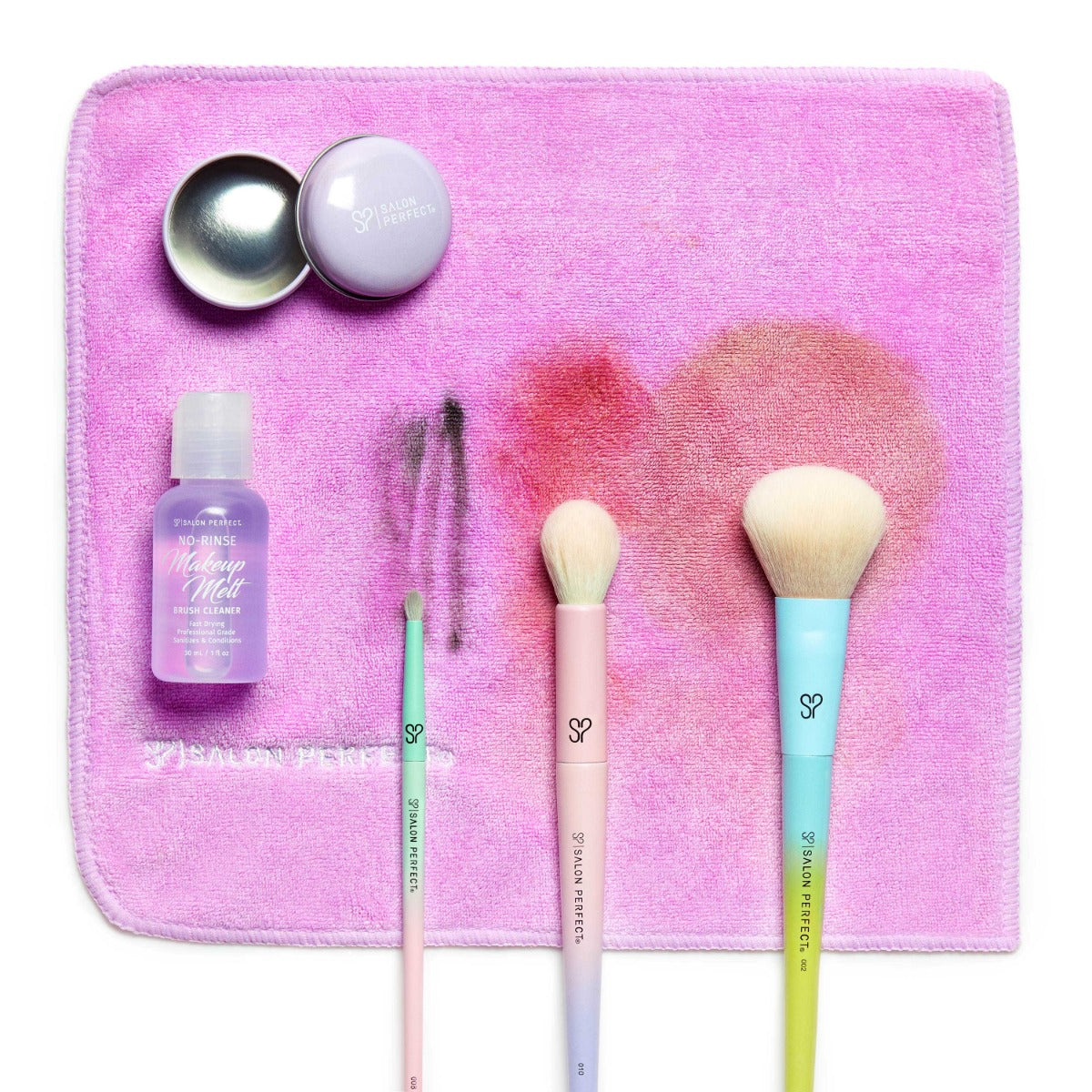 A stylized product shot showing different types of brushes their makeup residue left behind on the towel after cleaning.